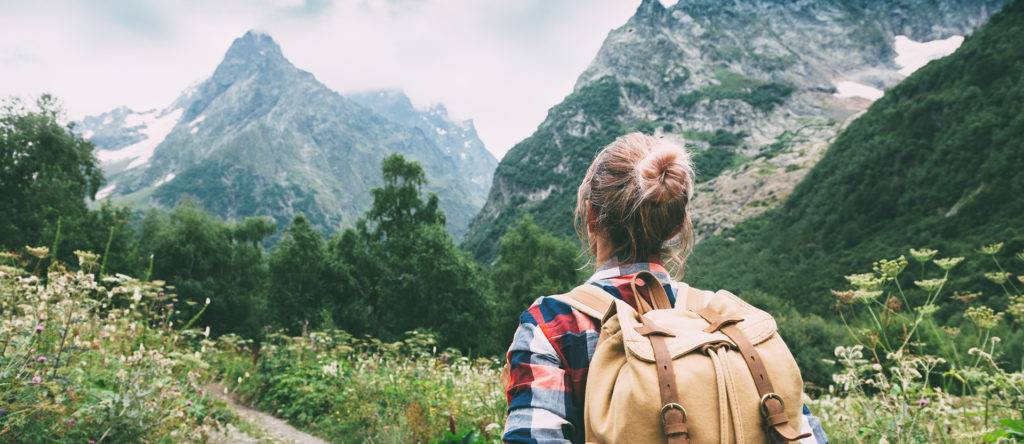 Young woman hiking through mountains